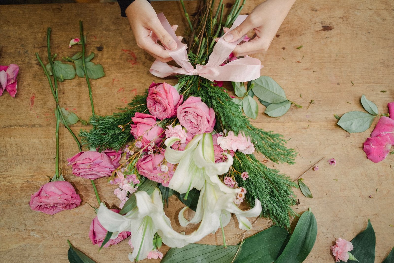 Florist tying ribbon on bouquet - The Petal Studio Chandigarh
