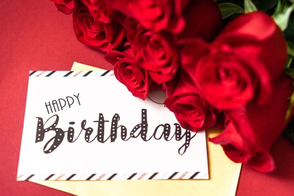 Red roses with a Happy Birthday card
